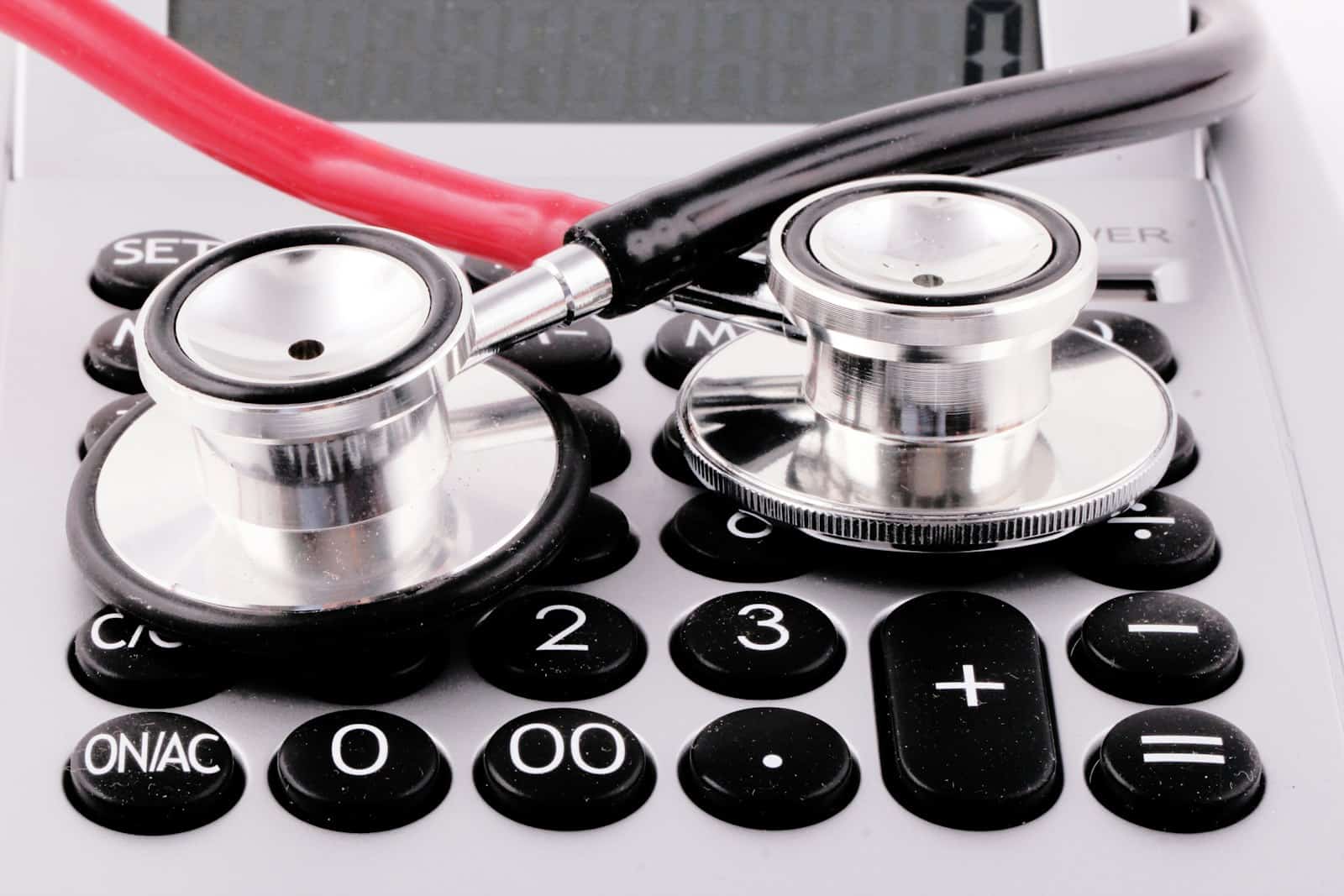 Stethoscope resting on a calculator, illustrating Medicare reimbursement and cash-flow risk